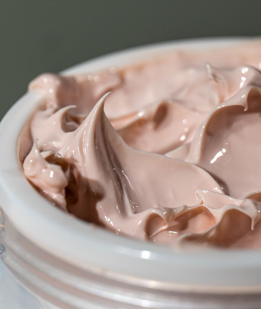 Up close shot of the Erasa SPF-30 Lifting/Sculpting Créme. The texture is smooth, light, airy. The color of the créme is a soft blush pink.